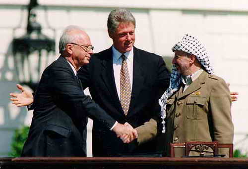 Yitzhak Rabin (links) und PLO-Chef Yasir Arafat nach der Unterzeichung des PLO-Abkommens im September 1993. U.S. President Bill Clinton (mitte)
